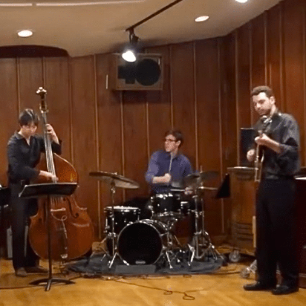 Jazz ensemble performing with upright bass, drums, and guitar