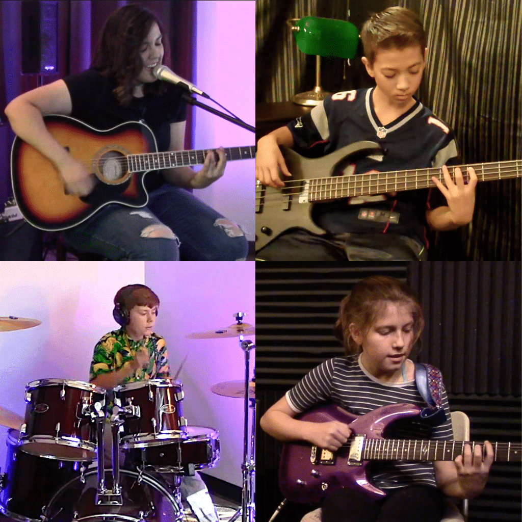 four students singing and playing guitar, bass and drums