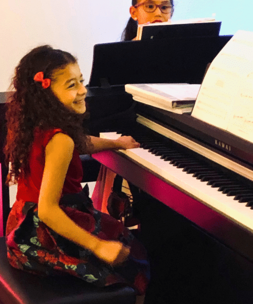 Piano students enjoying their music lesson