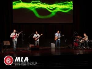 Adult Music Classes band jamming on stage during live performance